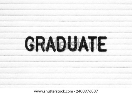 Black color letter in word graduate on white felt board background Royalty-Free Stock Photo #2403976837