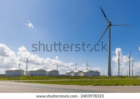 Storage of fuels and wind turbines in Eemshaven seaport in the north-east of province Groningen in The Netherlands Royalty-Free Stock Photo #2403978323