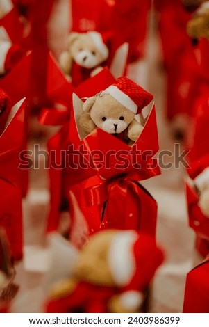 red wrapped christmas gift with teddy bear toy
