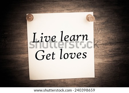 live learn get loves text on note paper and vintage wood 
