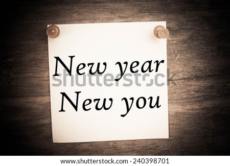 New year new you text on note paper and vintage wood 