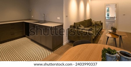 High resolution of a modern interior design of a kitchen and leaving-room after remodeling- Israel Royalty-Free Stock Photo #2403990337