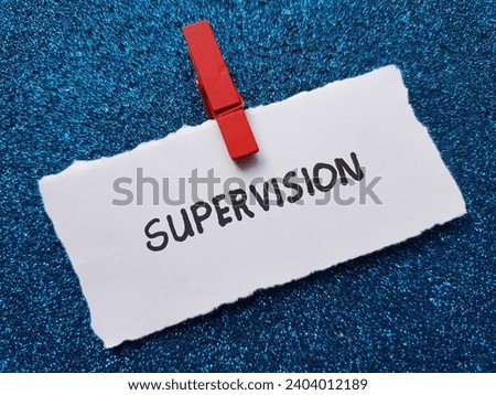 The word supervision is written on a blue background. Royalty-Free Stock Photo #2404012189