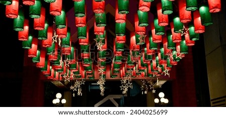 Christmas background with Green and Red Paper Lanterns hang above in beautiful rows background for design and decoration at Thailand. Selective Focus.