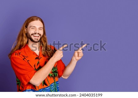 Portrait of positive man with ginger hairdo wear stylish shirt indicating at promo empty space isolated on purple color background