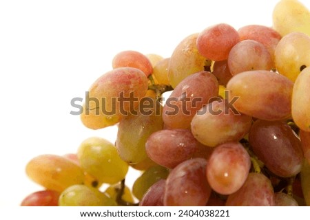Close up view of pink grapes berries with soft shadow isolated on white background.
