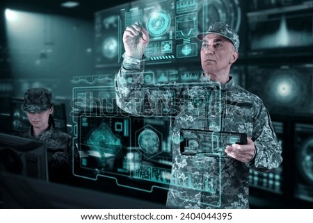 Military Think Tank, AI technology in the army. Warfare analytic operator checking coordination of the military team. Military commander with a digital device with augmented reality operating troops. Royalty-Free Stock Photo #2404044395