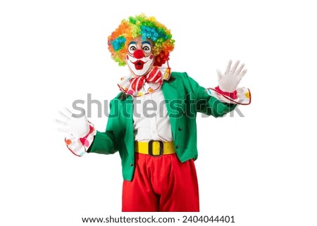 Funny clown. Entertainer Joker in colorful suit and wig. Buffoon with clown whiteface makeup. Trickster, jester, pantomime, mime. Professional actor at event, kids party, circus Royalty-Free Stock Photo #2404044401
