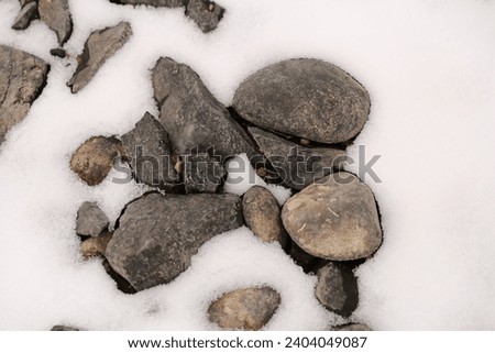 River rocks with a snow background