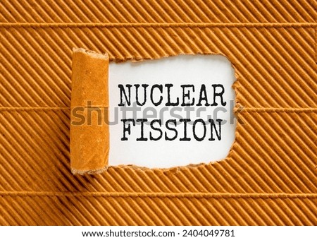 Nuclear fission symbol. Concept words Nuclear fission on beautiful white paper. Beautiful brown paper background. Business science nuclear fission concept. Copy space. Royalty-Free Stock Photo #2404049781