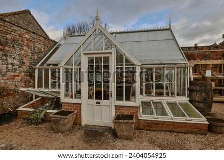Outdoor greenhouse. Victorian era styling. Royalty-Free Stock Photo #2404054925