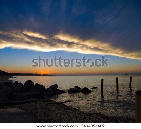 As a storm passed, the cloud line gave way to a blue sky and a beautiful sunset on the North Fork of Long Island, NY