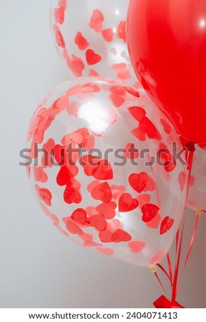 red latex balloons with helium on a white background