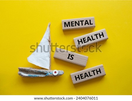 Mental Health symbol. Wooden blocks with words Mental Health is Health. Beautiful yellow background with boat. Medical and Health concept. Copy space.