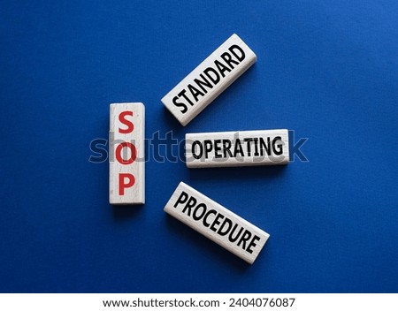SOP - Standard Operating Procedure symbol. Wooden blocks with word SLA. Beautiful deep blue background. Business and Service Level Agreement concept. Copy space. Royalty-Free Stock Photo #2404076087