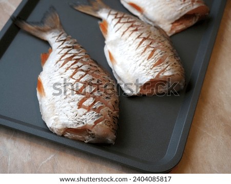 Ready-to-cook, scaled, cleaned bream, Common roach. Freshwater fish ready to fry.