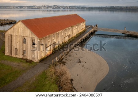 Old aged Semiahmoo Cannery Building at Tounge Point on Semiahmoo Spit in Blaine, WA. Salmon canning was once a roaring business here on the Semiahmoo Spit that brought many businesses to the spit. Royalty-Free Stock Photo #2404088597