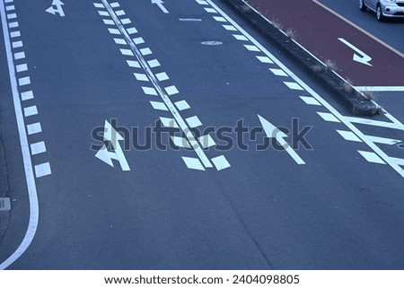 Japanese road traffic signs. Various signs are written on the road for traffic safety. Also, like in the UK, Japanese vehicles drive on the left. Royalty-Free Stock Photo #2404098805