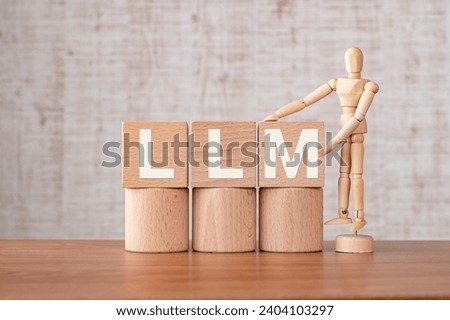 There is wood cube with the word LLM. It is an abbreviation for Large Language Models as eye-catching image. Royalty-Free Stock Photo #2404103297
