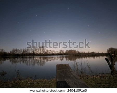A picture of the night sky above a fishing lake 