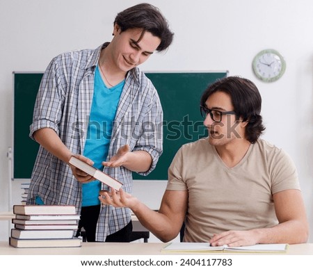 Two male students in the classroom Royalty-Free Stock Photo #2404117783