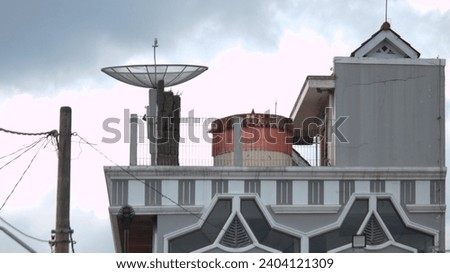 a television satellite dish installed on top of a building.