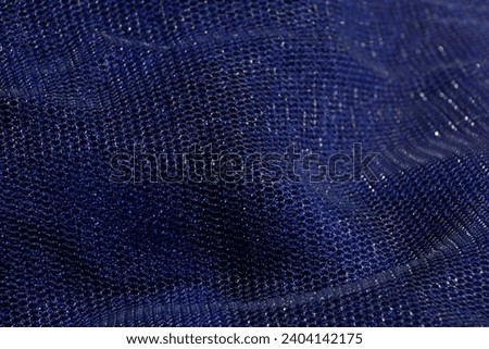 Photo of a background made from a blue clothwith a small mesh.