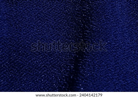 Photo of a background made from a blue clothwith a small mesh.