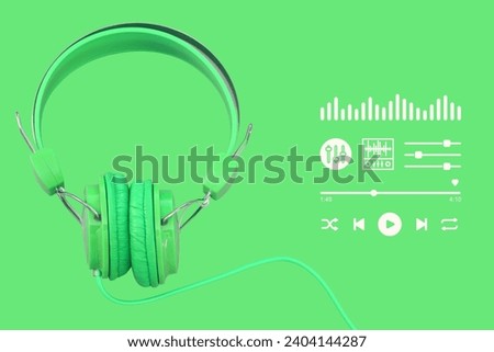 Picture of headphones on a green background There is a playback symbol and an equalizer button in the picture. Suitable for use in music media, advertising media, and teaching media. Royalty-Free Stock Photo #2404144287