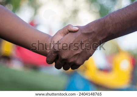 Two people doing handshake and blurred background