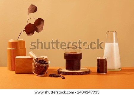 A cup of black coffee is displayed on a log, autumn leaves are placed in a ceramic vase. Coffee display space for advertising. Coffee contains many antioxidants that are beneficial for the skin. Royalty-Free Stock Photo #2404149933