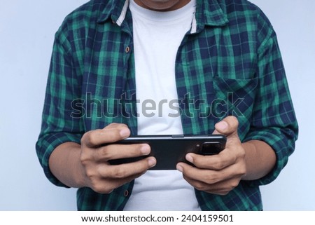 a guy playing game using mobile phone. isolated white
