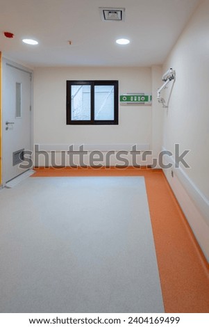 Vibrant empty hospital rooms with modern orange and grey flooring, radiating a calming yet professional atmosphere
