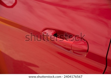 Shiny Red car door handle close up details, Car metal body.