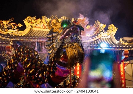 A Chinese dragon in front of a Chinese temple Royalty-Free Stock Photo #2404183041