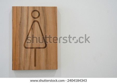 Women toilet sign made from wood on white background. Interior design. Copy space
