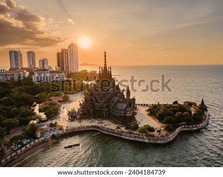 Skyline of Pattaya city at sunset with The Sanctuary of Truth wooden temple in Pattaya Thailand, gigantic wooden construction located at the cape of Naklua Pattaya City Chonburi Thailand Royalty-Free Stock Photo #2404184739