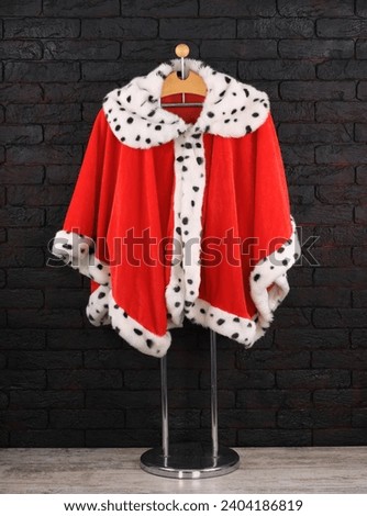 red royal robe on a hanger Royalty-Free Stock Photo #2404186819