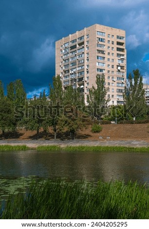 Kyiv residential architecture in Former USSR era - architectural style. Made of concrete blocks. Rusanivka Kyiv district . Lush foliage summer 
 Royalty-Free Stock Photo #2404205295
