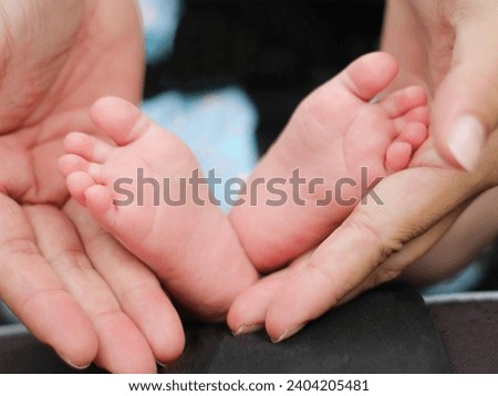 Baby’s feet Global family day Mon, Jan 1, 2024 Royalty-Free Stock Photo #2404205481
