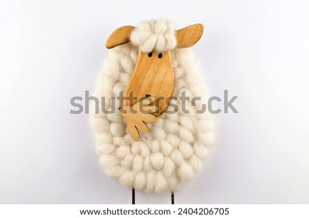 A picture of sheep made with cotton buds and wood