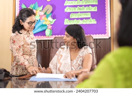 Confident businesswoman, with her personal assistant attending a meeting in the conference room. Important discussion.