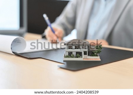A woman signing a real estate contract