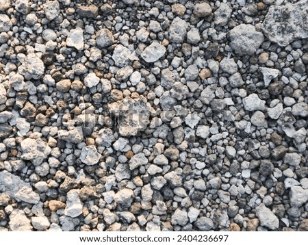 Small stones wall used for background texture.Small Rock Textured background. Seamless texture of gravel. crushed granite texture