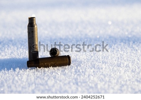Shell cases on white snow. Close up photo