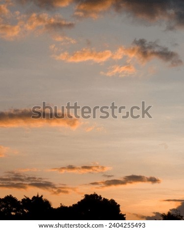 Sunset picture with orange, pink and yellow mixed color clouds. Aesthetic sunset picture. 