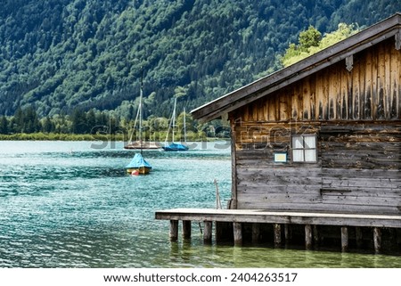     lake tegersee with wooden boatshouse                            Royalty-Free Stock Photo #2404263517