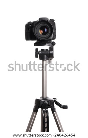 DSLR digital single lens reflex camera on a tripod isolated on white