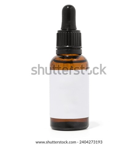 Amber glass dropper bottle on white background with blank label Royalty-Free Stock Photo #2404273193