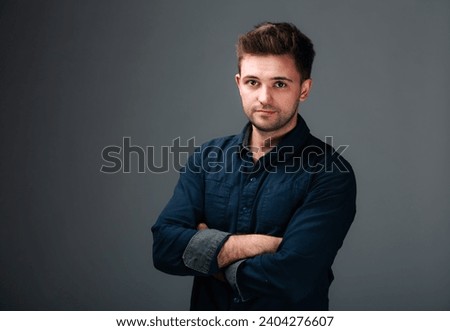 A Confident Man Striking a Pose. A man with his arms crossed posing for a picture